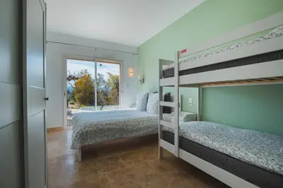 a bedroom with two bunk beds and a window at LE PETIT CHENE in Apt