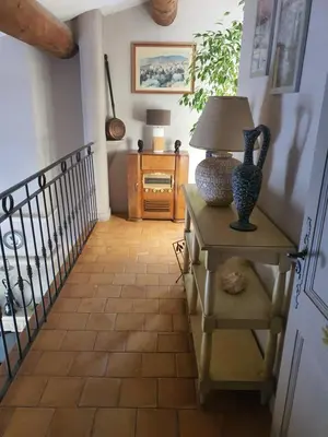 a hallway with a table with a lamp on it at Villa L'Estagniol in Lourmarin