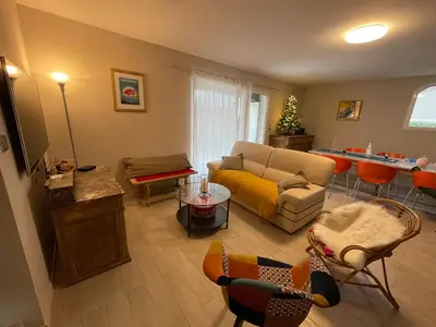 a living room with a couch and a table and chairs at Proche Saint Rémy de Provence in Mollégès