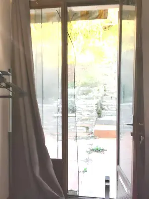 a sliding glass door leading to a patio at Maison de charme à Vachères avec jardin et vue montagne in Vachères