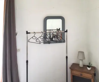 a mirror on a wall next to a table at Maison de charme à Vachères avec jardin et vue montagne in Vachères
