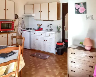 a kitchen with white cabinets and a sink at Maison de charme à Vachères avec jardin et vue montagne in Vachères