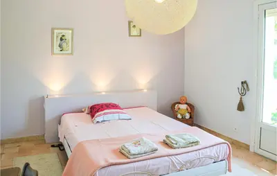a bedroom with a bed with two towels on it at Nice Home In Lançon-Provence in Lançon-Provence