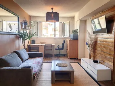 a living room with a couch and a table at Plein centre ville Appartement in Salon-de-Provence