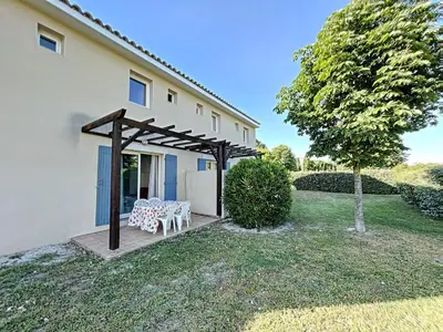 a picnic table under a pergola outside of a house at Casa De Provence in Saint-Saturnin-les-Avignon