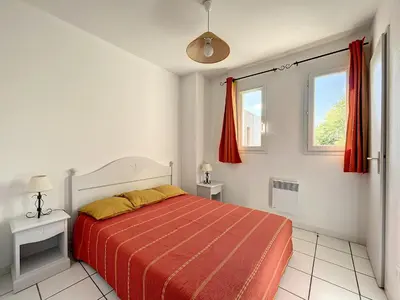 a white bedroom with a bed and two windows at Casa De Provence in Saint-Saturnin-les-Avignon