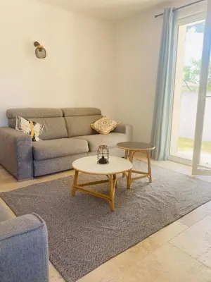 a living room with a couch and a table at La Maison d à côté 8 à 10 personnes in Carpentras