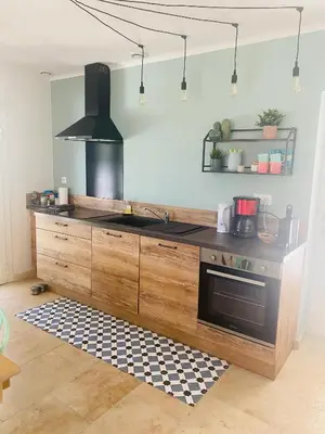 a kitchen with a sink and a stove at La Maison d à côté 8 à 10 personnes in Carpentras