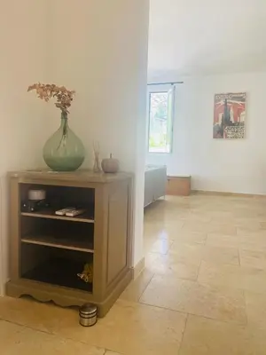 a room with a vase on top of a table at La Maison d à côté 8 à 10 personnes in Carpentras
