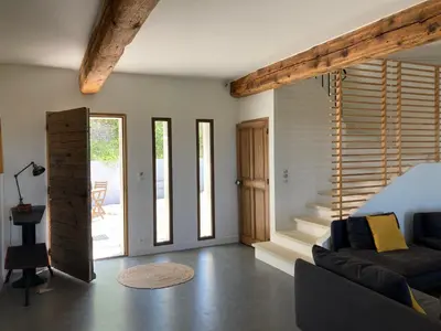 a living room with a couch and a staircase at La bastide in Malemort-du-Comtat