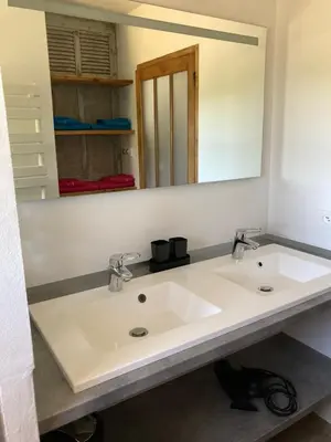 a bathroom with a white sink and a mirror at La bastide in Malemort-du-Comtat