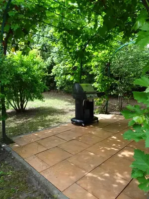 a trash can sitting next to a bench in a park at The Blue Tit - private swimming pool in LʼIsle-sur-la-Sorgue