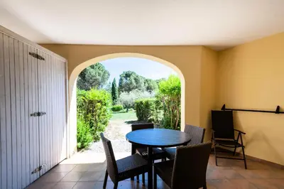 a dining room with a table and chairs and an archway at Village Pont Royal en Provence - maeva Home - Studio 5 personnes - Sélection MAE-2824 in Mallemort