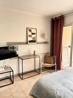a bedroom with a bed and a desk and a chair at Village Pont Royal en Provence - maeva Home - Studio 4 personnes - Sélection MAE-2934 in Mallemort