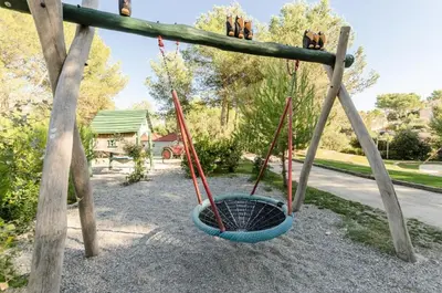 a swing yard with two swings and a basket at Village Pont Royal en Provence - maeva Home - Studio 4 personnes - Sélection MAE-2934 in Mallemort