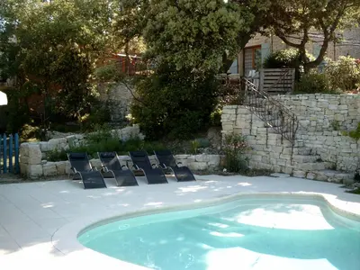 a swimming pool with lounge chairs next to a yard at PROVENCE SOLEIL LUBERON PISCINE in Apt
