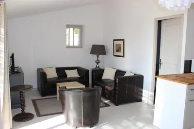 a living room with a couch and a table at Gîte Les Rapières in Gordes
