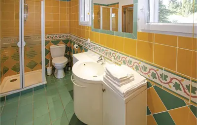 a bathroom with a sink and a toilet and a shower at Amazing Home In Caumont Sur Durance in Caumont-sur-Durance