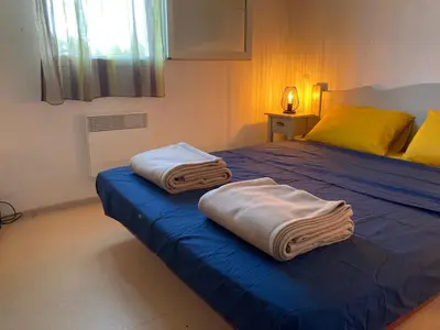 a bedroom with a bed with two towels on it at Les demeures du Ventoux in Aubignan