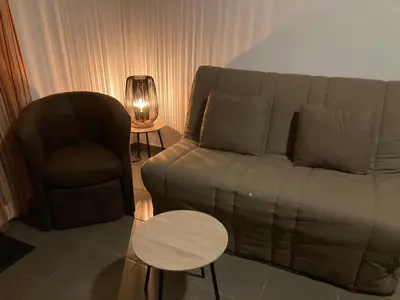 a living room with a couch and a chair at Les demeures du Ventoux in Aubignan