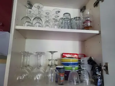 a shelf filled with glasses and other glass items at Les demeures du Ventoux in Aubignan
