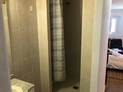 a bathroom with a shower with a toilet and a bed at La Tour- Pigeonnier Provençal - Mas des Sous Bois in Ventabren