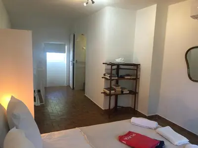 a room with a bed and a hallway with a mirror at La Tour- Pigeonnier Provençal - Mas des Sous Bois in Ventabren