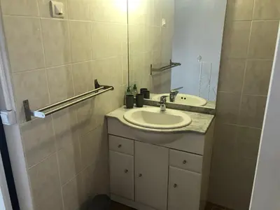 a bathroom with a sink and a mirror at La Tour- Pigeonnier Provençal - Mas des Sous Bois in Ventabren