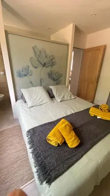 a bed with two towels on top of it at Gite Couleur Terre à 10MN de Gordes in Croagnes