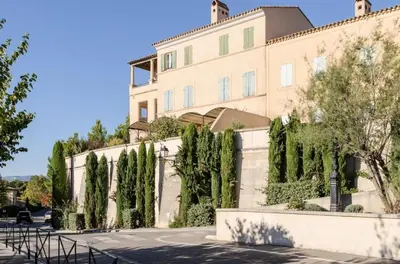 a building with trees in front of it at Les Maisons de Pont Royal en Provence - maeva Home - Maison climatisée pour 8 Personnes avec jardin privatif et terrasse MAE-2283 in Mallemort