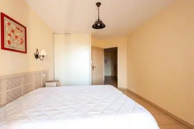 a bedroom with a large white bed in a room at Les Coteaux de Pont Royal en Provence - maeva Home - Appartement 2 Pièces 4 Personnes - Confort MAE-6002 in Mallemort