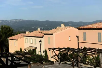 a group of buildings with a view of a town at Les Coteaux de Pont Royal en Provence - maeva Home - Maison 4 Pièces 8 Personnes - Budget MAE-6009 in Mallemort