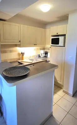 a kitchen with a white refrigerator and a counter top at Les Coteaux de Pont Royal en Provence - maeva Home - Maison 4 Pièces 8 Personnes - Sélection MAE-6014 in Mallemort
