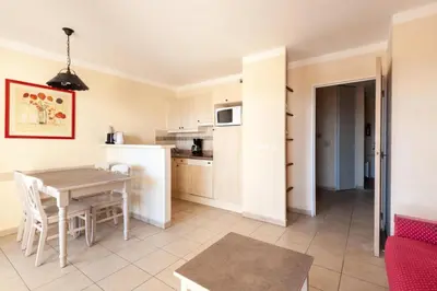a kitchen and living room with a table and chairs at Les Coteaux de Pont Royal en Provence - maeva Home - Appartement 2 Pièces 4 Personnes - Sélection MAE-6016 in Mallemort