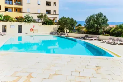 a swimming pool with chairs and a building at Les Coteaux de Pont Royal en Provence - maeva Home - Appartement 2 Pièces 4 Personnes - Sélection MAE-6017 in Mallemort
