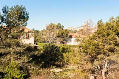 a view of a park with trees and a building at Les Coteaux de Pont Royal en Provence - maeva Home - Maison 4 Pièces 8 Personnes - Sélection MAE-6026 in Mallemort