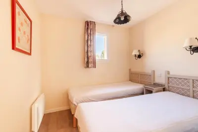 a room with two beds and a window at Les Coteaux de Pont Royal en Provence - maeva Home - Maison 4 Pièces 8 Personnes - Sélection MAE-6026 in Mallemort