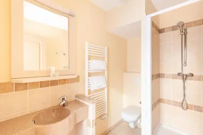 a bathroom with a sink and a toilet and a mirror at Les Coteaux de Pont Royal en Provence - maeva Home - Maison 4 Pièces 8 Personnes - Sélection MAE-6026 in Mallemort
