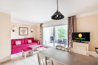 a living room with a pink couch and a table at Les Coteaux de Pont Royal en Provence - maeva Home - Appartement 2 Pièces 6 Personnes - Sélection MAE-8180 in Mallemort