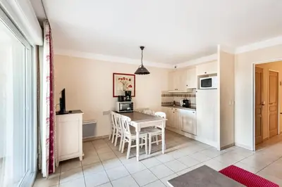 a kitchen and dining room with a table and chairs at Les Coteaux de Pont Royal en Provence - maeva Home - Appartement 2 Pièces 6 Personnes - Sélection MAE-8180 in Mallemort