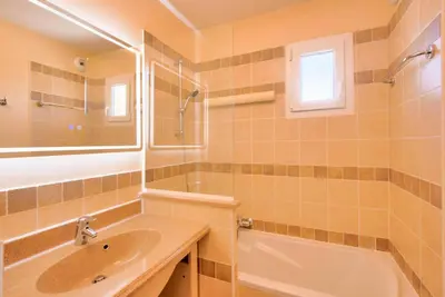 a bathroom with a sink and a tub and a mirror at Les Coteaux de Pont Royal en Provence - maeva Home - Appartement 4 pièces 7 personnes - Prestige - super Home MAE-2094 in Mallemort