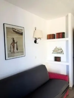 a living room with a black couch and a lamp at Les Coteaux de Pont Royal en Provence - maeva Home - Appartement 4 pièces 7 personnes - Prestige - super Home MAE-2094 in Mallemort