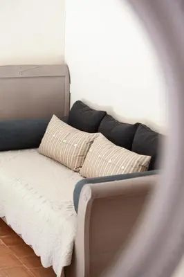 a couch with two pillows on top of it at Le Clos d'Estellan - Piscine chauffée in Bonnieux