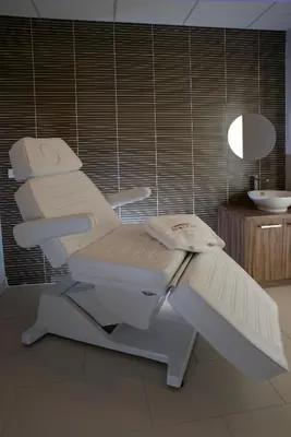 a white chair in a bathroom with a sink at Domitys Les Cigales du Lubéron in Cavaillon