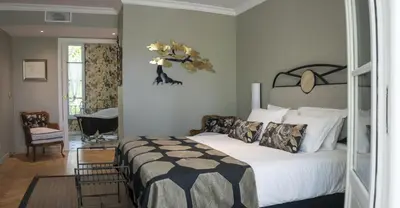 a bedroom with a bed with a black and white comforter at Villa Amara in Aix-en-Provence