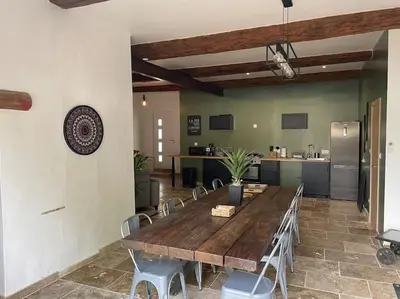 a large wooden table and chairs in a kitchen at Maison de charme avec piscine in Monteux