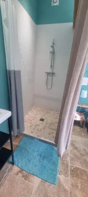 a bathroom with a shower with a shower curtain at Les cabanons de l'Oliveraie in Pernes-les-Fontaines