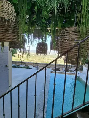 a balcony with a fence and a swimming pool at Maison au centre du village de Gordes avec vue incroyable in Gordes