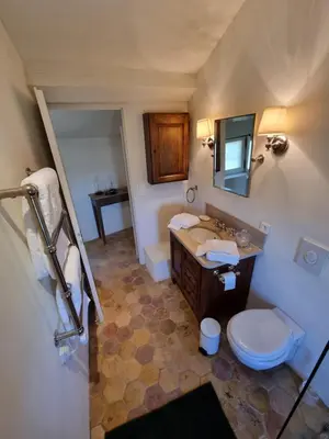 a bathroom with a toilet and a sink and a mirror at Maison au centre du village de Gordes avec vue incroyable in Gordes