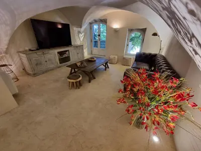 an overhead view of a living room with a couch and a television at Maison au centre du village de Gordes avec vue incroyable in Gordes